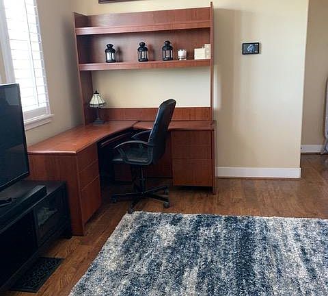 Living Room with 55 inch tv and work desk.