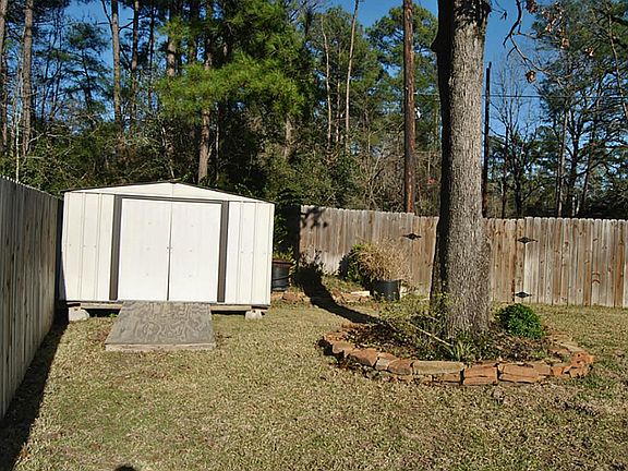 Large storage shed in corner of yard.