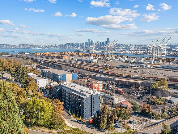 Take in the stunning aerial view of the port, showcasing the vibrant surroundings and the proximity of Harbor Flats to the waterfront.