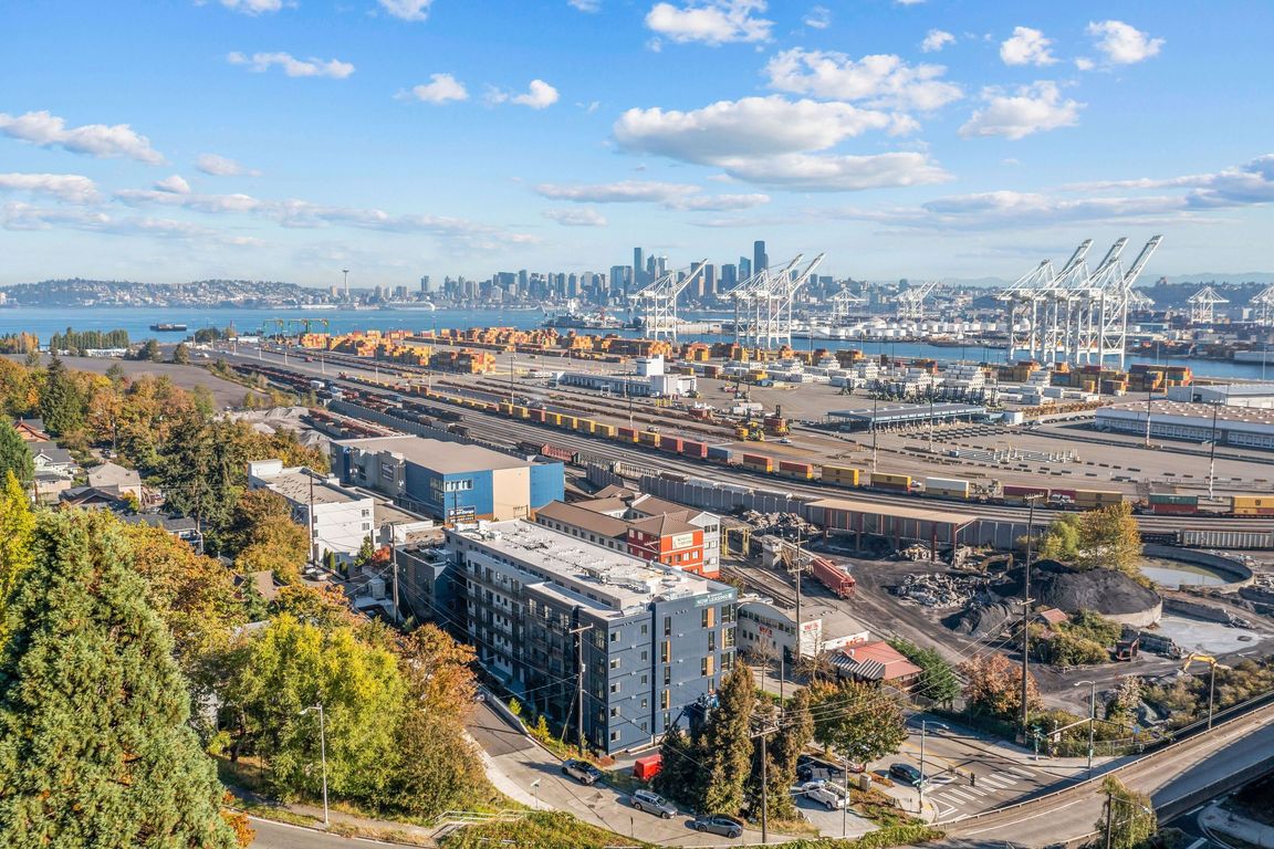 Take in the stunning aerial view of the port, showcasing the vibrant surroundings and the proximity of Harbor Flats to the waterfront.
