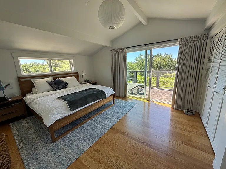 The upstairs primary bedroom and balcony