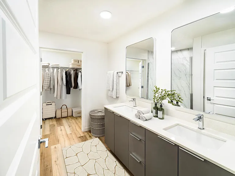 A bright primary bath with generous storage and a spacious closet, offering refined comfort at Modera Encore.