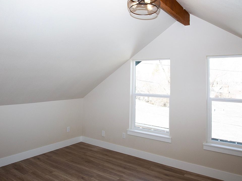 Bedroom 301 is oversized with two operable windows for lots of natural light. Beam ceilings and industrial lighting reveal classic character of home.
