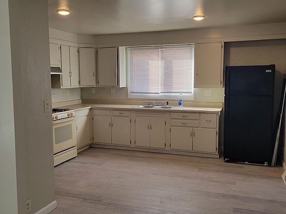 Plenty of cabinets; gas stove; opens to dining area and living area.