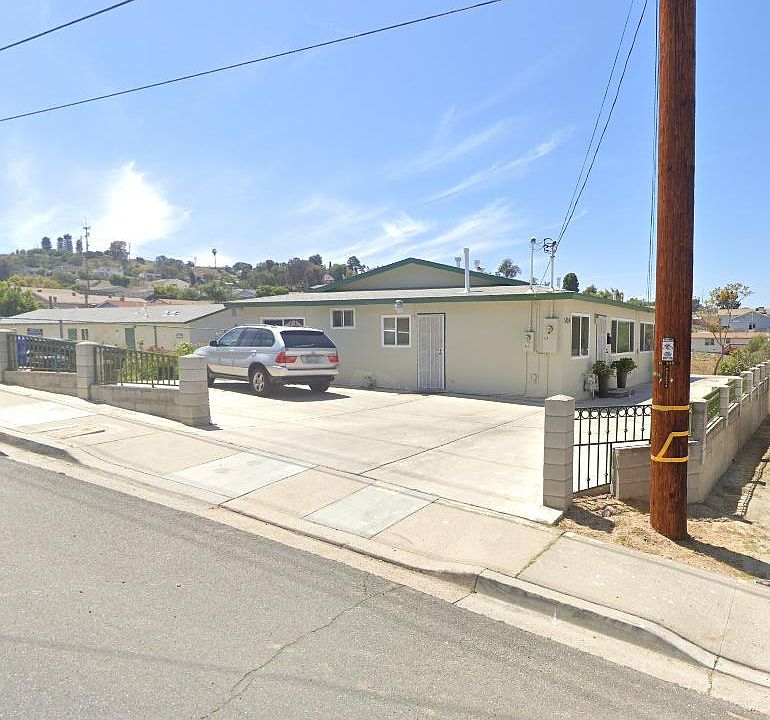 Large yard with 2 parking spaces, front and side entrances.