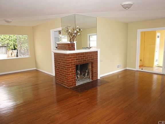 Large living room and dining area and fireplace.