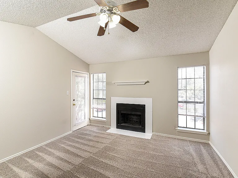 One Bedroom A2 - Living Area with Vaulted Ceiling and Fireplace