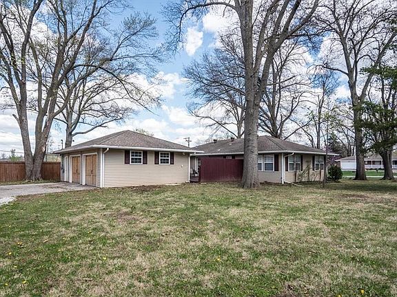 View from driveway. Notice the deck with privacy fence between garage and house.