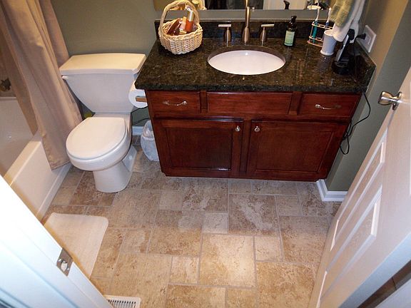 Hand tiled shower and floor. Granite vanity top with new cabinets. 2009.