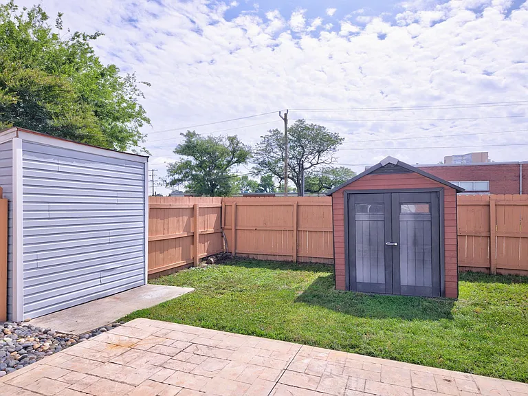 Fully fenced backyard with shed