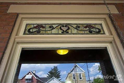 Large picture window with stain glass transome window above.