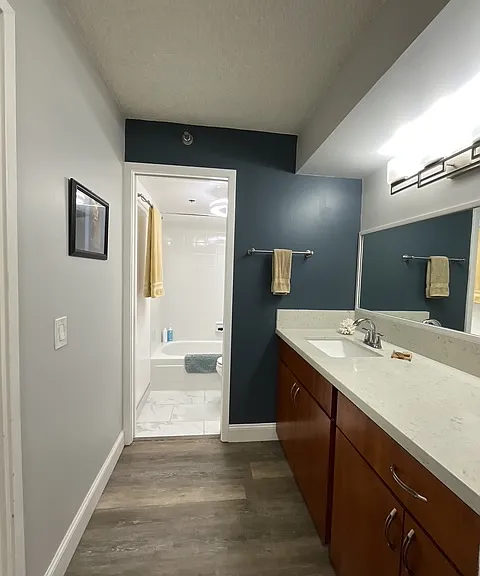 bathroom with remodeled tub, all new plumbing and high end shower head, new tile flooring, and toilet with bidet