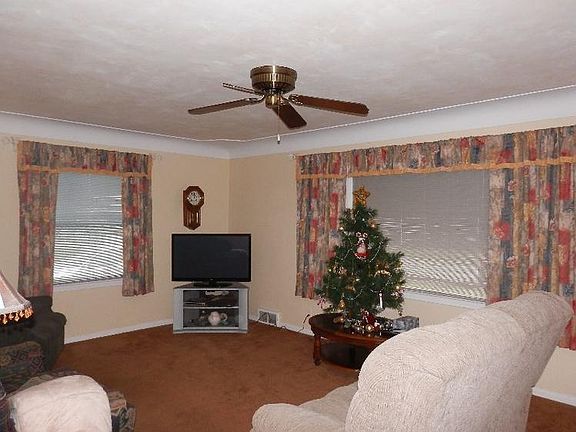 Pleasant living room offers ceiling fan