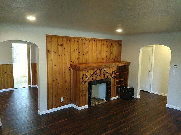 Large living room opening up to the dining/kitchen on the left and bedrooms to the right.