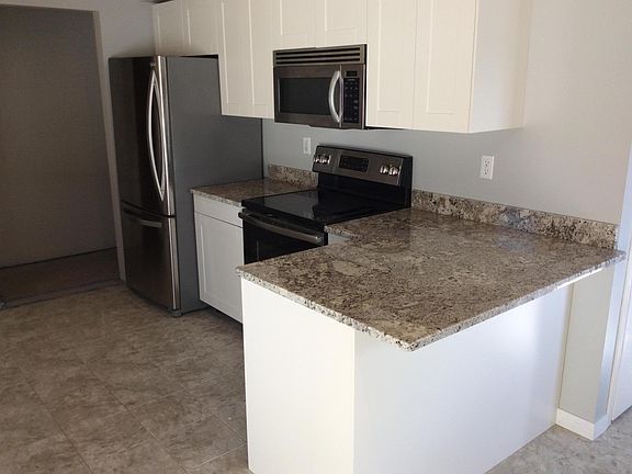 Brand new kitchen features stainless appliances, granite cou