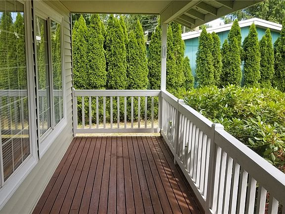 Super cute covered front porch, with privacy rhododendron hedge. Enjoy your front yard even when it's raining. Owner will re-stain porch with buyer's choice of color (with full priced offer)