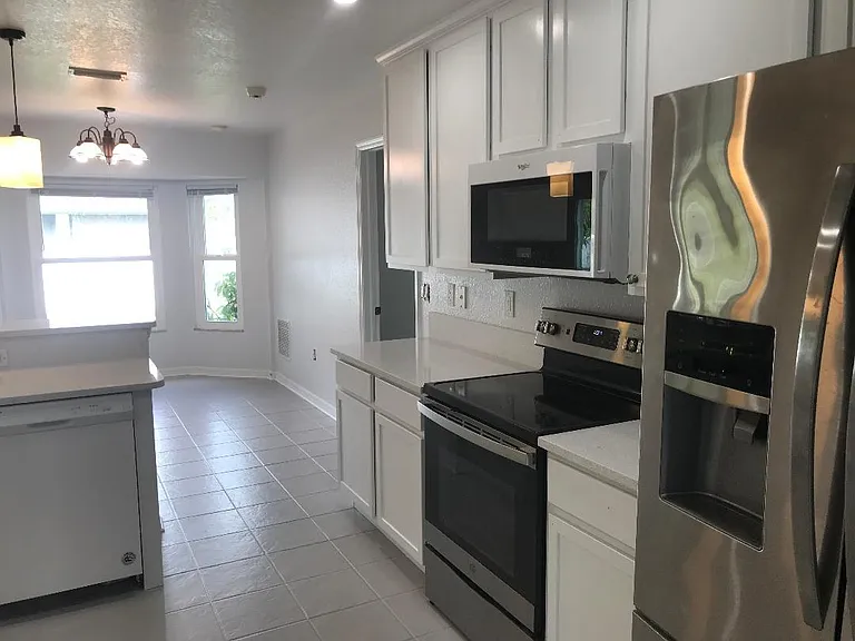 kitchen with new appliances and quartz counters