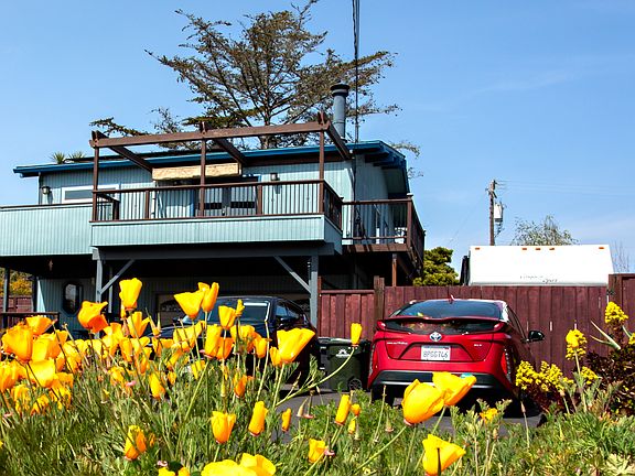 Beach house style home (Living, Kitchen, Primary bedroom, Primary bathroom on second floor). Established gardens on watering system with gardening service included.