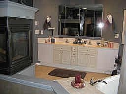Amazing master bath with three sided fireplace and jetted whirlpool tub.