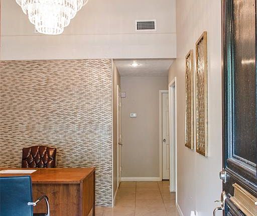 Smart use of space here with vaulted ceilings, tile flooring, and notice the Mosaic tile accent wall.