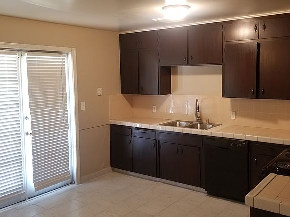 Kitchen with French doors leading to backyard covered patio.