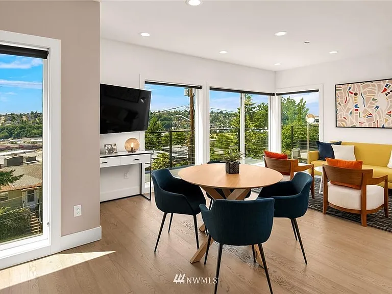 The living and dining area with wall of windows.