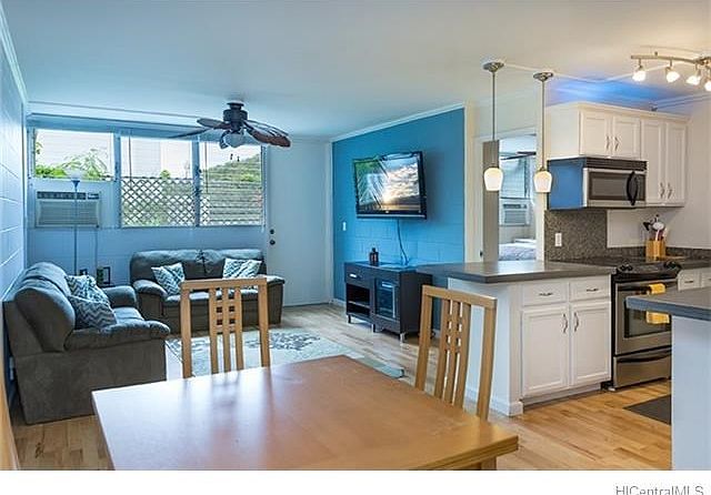 A view to the living area including the kitchen and dining area.