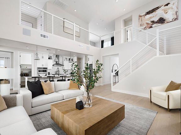 Open gathering area with view of kitchen