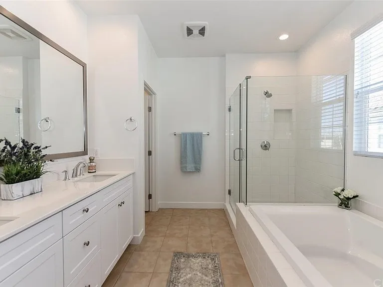 Primary ensuite bathroom with large tub and shower