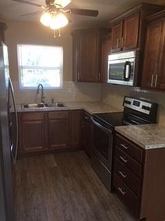 Beautiful, brand new kitchen with crown molding.