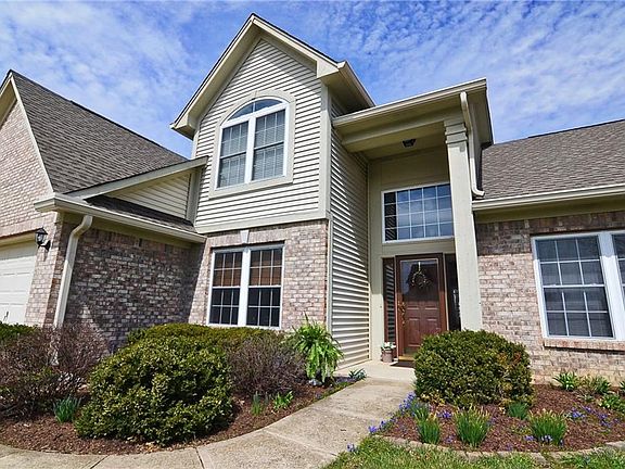 Beautiful and stately entry with glass entry door. New landscape mulch 2018