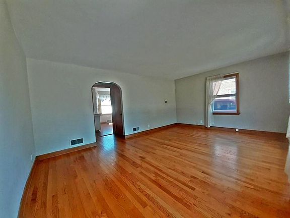 Into a large LR w/oak flooring