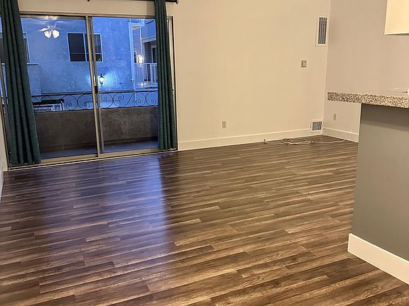 Dining/living area. Spacious, clean and bright! Brand new floors and paint. Glass doors out to private balcony