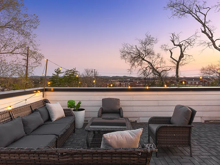 Private rooftop deck with plenty of seating and outdoor lights, allowing you to enjoy your morning cup of coffee or a late night conversation while overlooking the skyline.