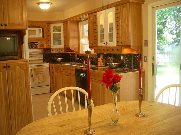kitchen viewing from dining area (oak cabinets and natural stone counters)