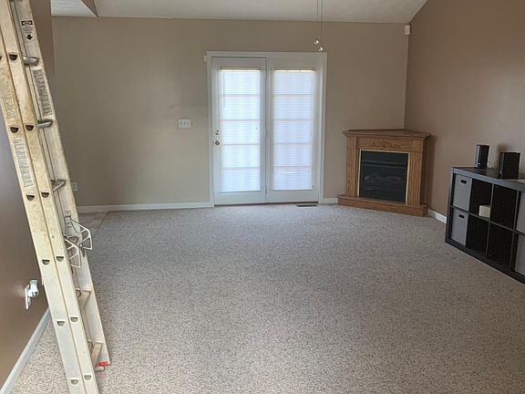 Entry to home with view of gas fireplace.