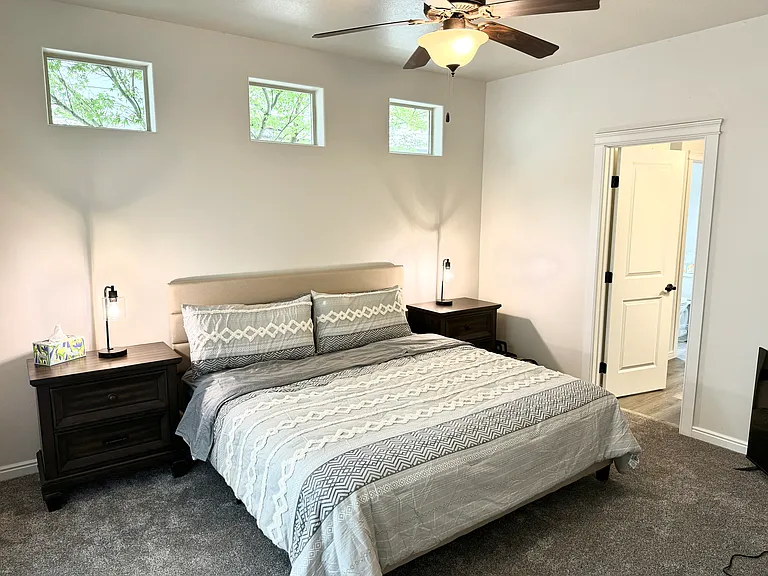 primary bedroom with attached bathroom and walk-in closet. Outside door to private patio.
