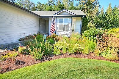 Close up of front of house showing beatifully kept garden.