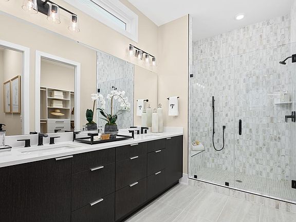 Luxurious primary bath with upgraded finishes and a zero-threshold shower