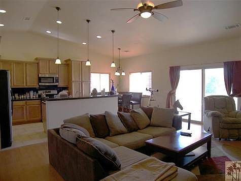 Open kitchen with dining area by corner windows.