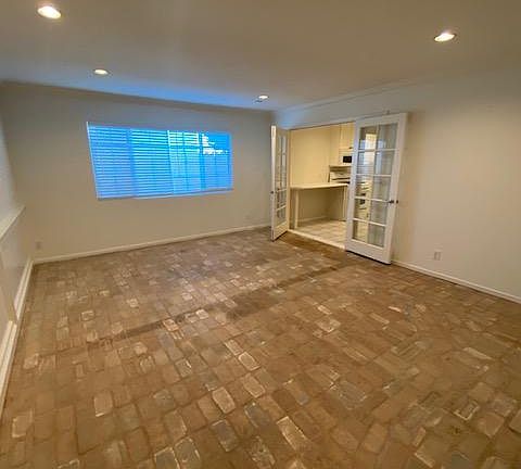 Spacious family room with beautiful brick floors, room for a large sectional and dining table.