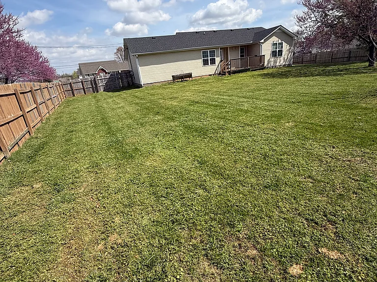 Large fenced backyard for pets to run freely.