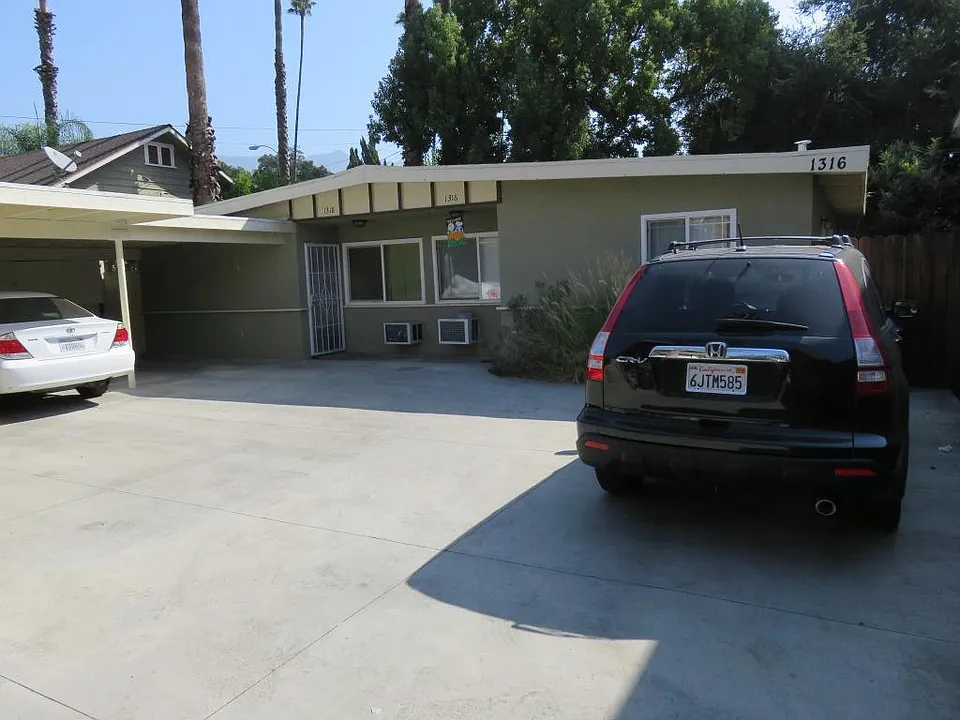 Looking at structure in the back with two units. Unit to left is for rent.
