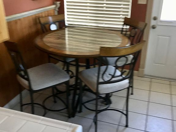 Kitchen door to side yard, garage, and trash/recycling