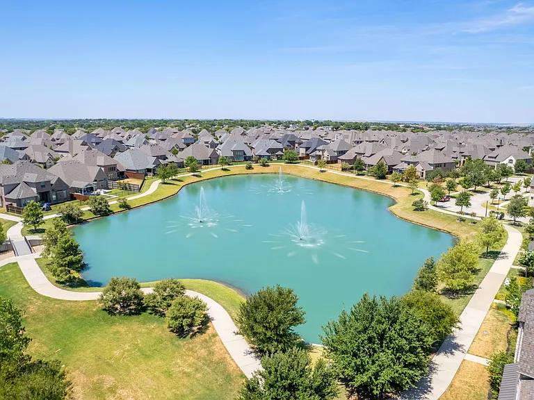 Tranquil pond with fountain and trail