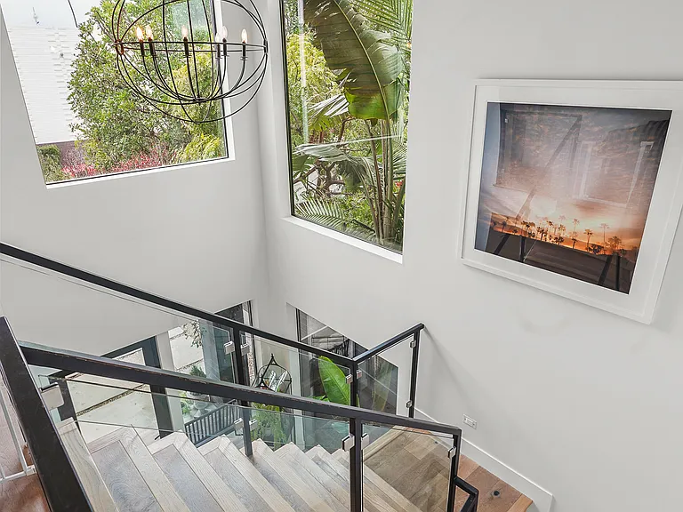 The home is flooded with natural light and surrounded by mature plantings