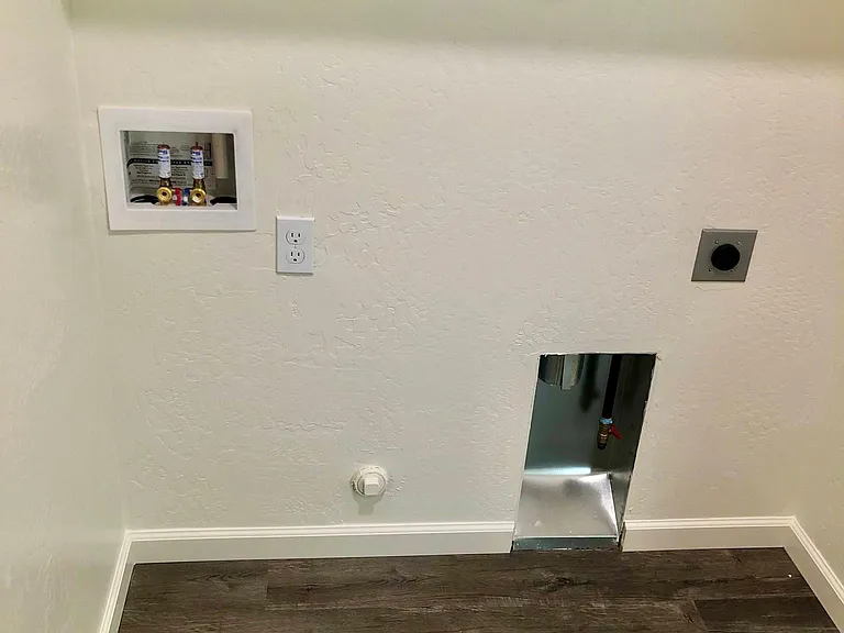 Laundry room with hookups, upper shelves.