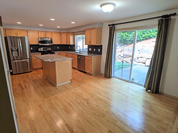 Upgraded kitchen with stainless steel appliances and granite countertops