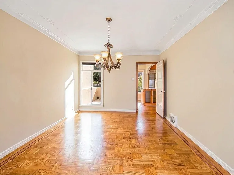 Large Formal Dining room on main level, can comfortably seat up to 12. Main level patio/deck seen in back left. House will be delivered unfurnished.