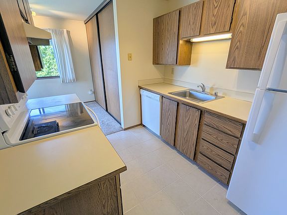 Kitchen with dishwasher and glass-top stove
